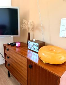 a wooden dresser with a flat screen tv on top of it at Joe's Home Naumburg -modern,vintage Apartment in Naumburg