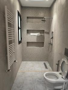 a bathroom with a toilet and a sink at Pearl Beach Apartment in Monastir