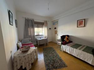 a room with a bed and a table in it at Studio coeur tanger in Tangier +3 photos