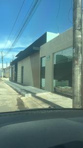 a building with garage doors on the side of a street at Flat mobiliado centro formosa Go in Formosa