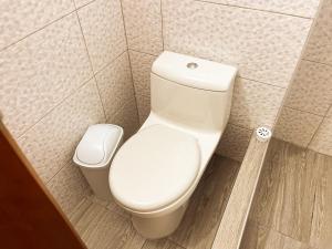 a bathroom with a toilet and a trash can at Ayllu in Huaraz +61 photos