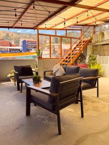 a patio with couches and a table on a roof at Ayllu in Huaraz