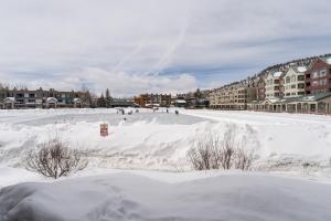 a snow covered beach with buildings in the background at Willows #1704 in Keystone
