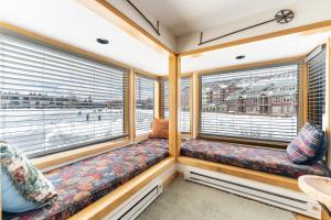 a room with two windows and a couch at Willows #1704 in Keystone