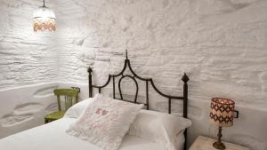 a bedroom with a bed with a white wall at Est 1852 Andros - Tower 2 in Lámira