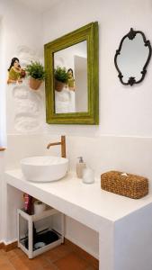a bathroom with a sink and a mirror at Est 1852 Andros - Tower 2 in Lámira