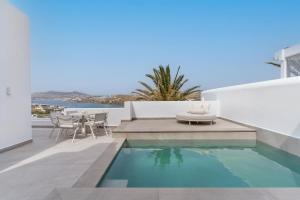 a swimming pool on the roof of a house at Kallos of Mykonos in Ornos