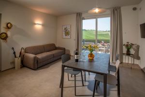a living room with a table and a couch at Radici in Serralunga d'Alba