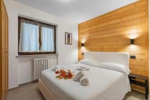 a bedroom with a white bed with towels on it at Rochebrune Apartments in Ski Resort in Claviere