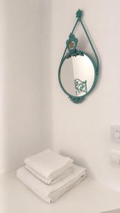 a pile of towels on a counter with a mirror at Est 1852 Andros - Tower 1 in Lámira
