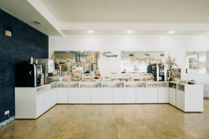 a store with white counters in a room at Hotel Holiday in Vasto