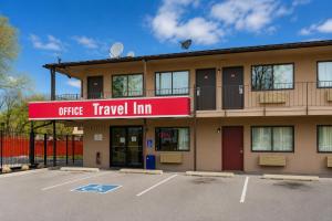 a building with a sign that reads office travel inn at Travel Inn By OYO Omaha in Millard