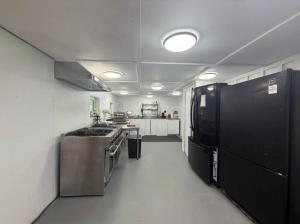 a large kitchen with a stove and a refrigerator at Leapin leanas in Monson +4 photos