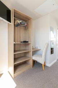 a room with a desk and a chair and a television at Almara Guesthouse in Galway