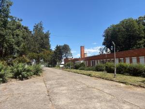 an empty street in front of a brick building at Tisza Garden Park in Tiszalök