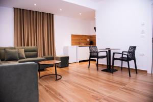a living room with a couch and a table and chairs at Dine Residence in Himare