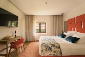 a bedroom with a large bed and a desk and a desk at Constance Retreat - Douro Verde by FERO in Constance +77 photos