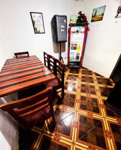 a dining room with a table and a refrigerator at Hostal El Viajero-Mindo in Mindo +28 photos