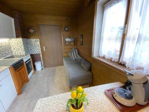 a small kitchen with a table with a vase of flowers at Ferienhaus Greti Ehrwald in Ehrwald