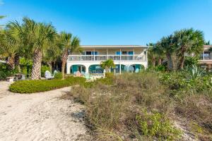 a large house on the beach with palm trees at Escape Coastal Resort on Casey Key in Nokomis