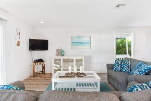 a living room with a couch and a coffee table at Escape Coastal Resort on Casey Key in Nokomis +205 photos
