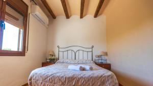 a bedroom with a bed with two pillows on it at Casa Rue in Deltebre +61 photos