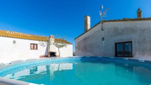 a large swimming pool in front of a building at Casa Rue in Deltebre