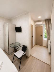 a small room with a table and a chair at Hotel Maria in Tbilisi City