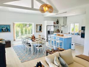 a kitchen and living room with a couch and a table at Villa Lottus in Carvalhal