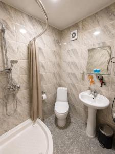 a bathroom with a toilet and a sink and a shower at Hotel Maria in Tbilisi City +33 photos
