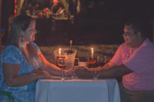 a man and woman sitting at a table with wine glasses at Bora Bora Temporada in Gamboa