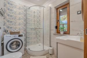 a bathroom with a washing machine and a sink at Vila Trate with Shared Pool and Garden in Ljutomer +75 photos