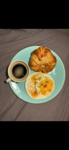 a plate of food with a pastry and a cup of coffee at DREAM Flat in PARIS in Levallois-Perret +11 photos