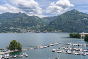 a group of boats docked in a harbor with mountains at B&B Antenhofer Lovere in Lovere