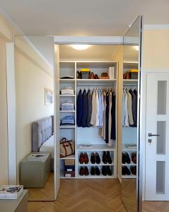 a walk in closet with a glass door at Elena Seaview Apartment in Vlorë