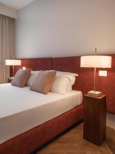 a bedroom with a bed with two lamps on it at Fill's Luxury Design Apartments 100m from the Beach in Rimini