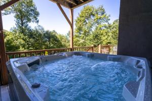 a jacuzzi tub on the back of a house at Evergreen Cottage in Blowing Rock