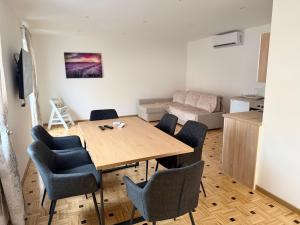 a living room with a dining room table and chairs at Apartma Viković II in Njiverce +7 photos