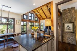 a kitchen and living room with a stone wall at Evergreen Cottage in Blowing Rock