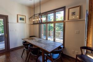 a dining room with a wooden table and chairs at Evergreen Cottage in Blowing Rock +27 photos