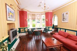 a living room with a couch and a table at Russell Hotel in Royal Tunbridge Wells