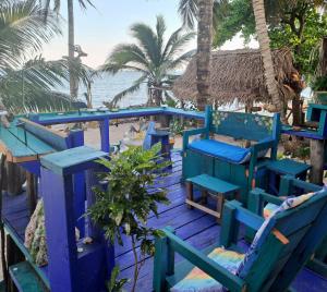 a bunch of blue chairs on a deck near the beach at Kismet Inn Semi Private in Hopkins