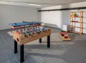 a ping pong table in a room with a table at Radici in Serralunga d'Alba