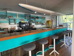 a bar in a restaurant with stools at Es Raco de Canyamel in Canyamel