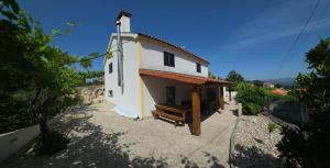 a small building with a porch on the side of it at Casa Sobreira de Mondim in Mondim de Basto