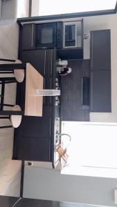 an overhead view of a kitchen with black cabinets at appartement de 45 m sur cour centre ville de morez in Morez +6 photos