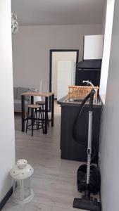 a room with a mop sitting on the floor at appartement de 45 m sur cour centre ville de morez in Morez
