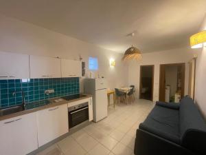 a kitchen and a living room with a couch at Via della Campana 17 in Portoferraio