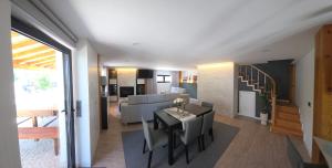 a living room and dining room with a table and chairs at Casa Sobreira de Mondim in Mondim de Basto