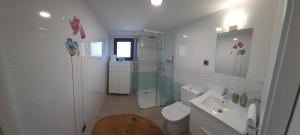 a white bathroom with a shower and a sink at Casa Sobreira de Mondim in Mondim de Basto +20 photos